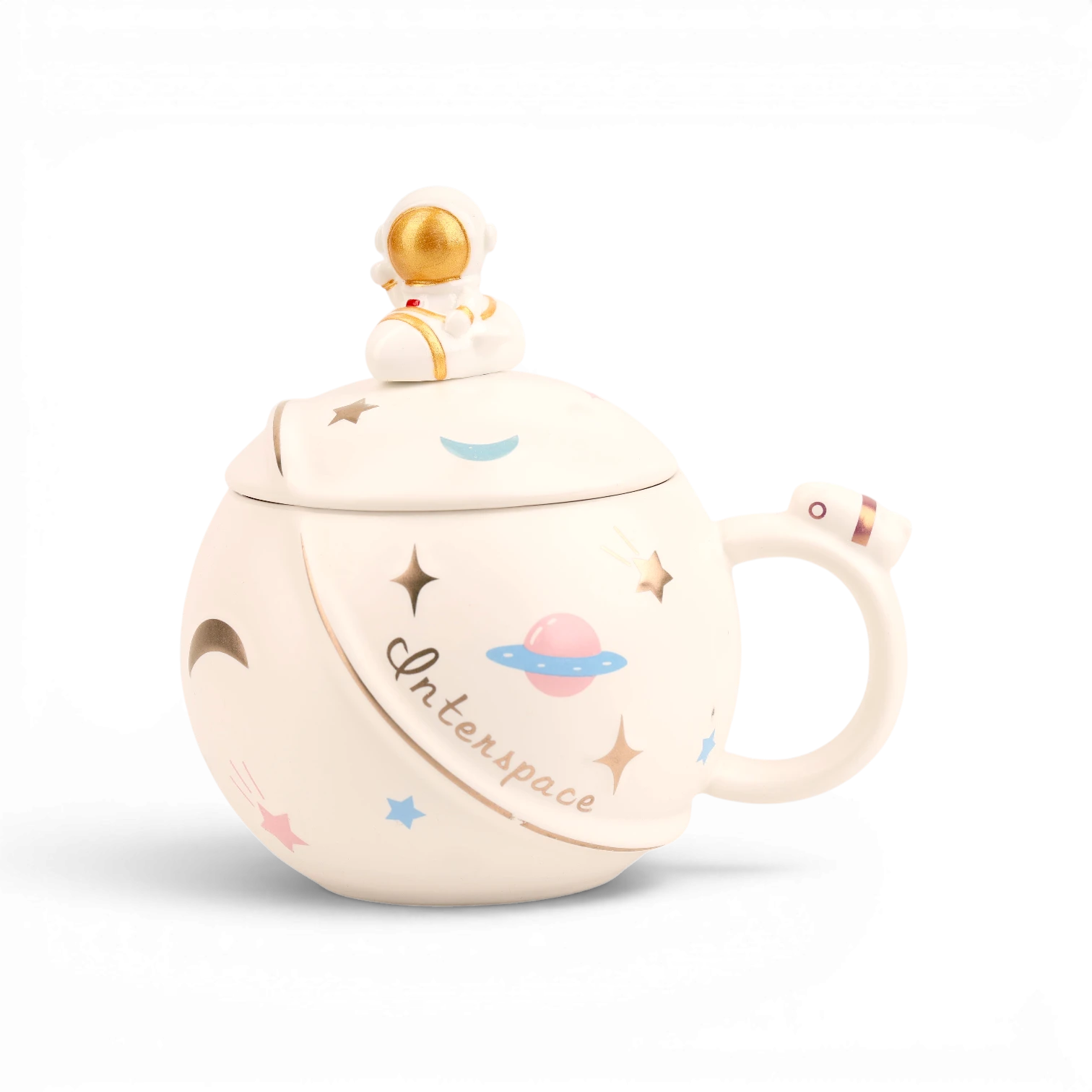 White ceramic mug with space-themed illustrations including planets, stars, and astronaut, topped with gold spaceman finial