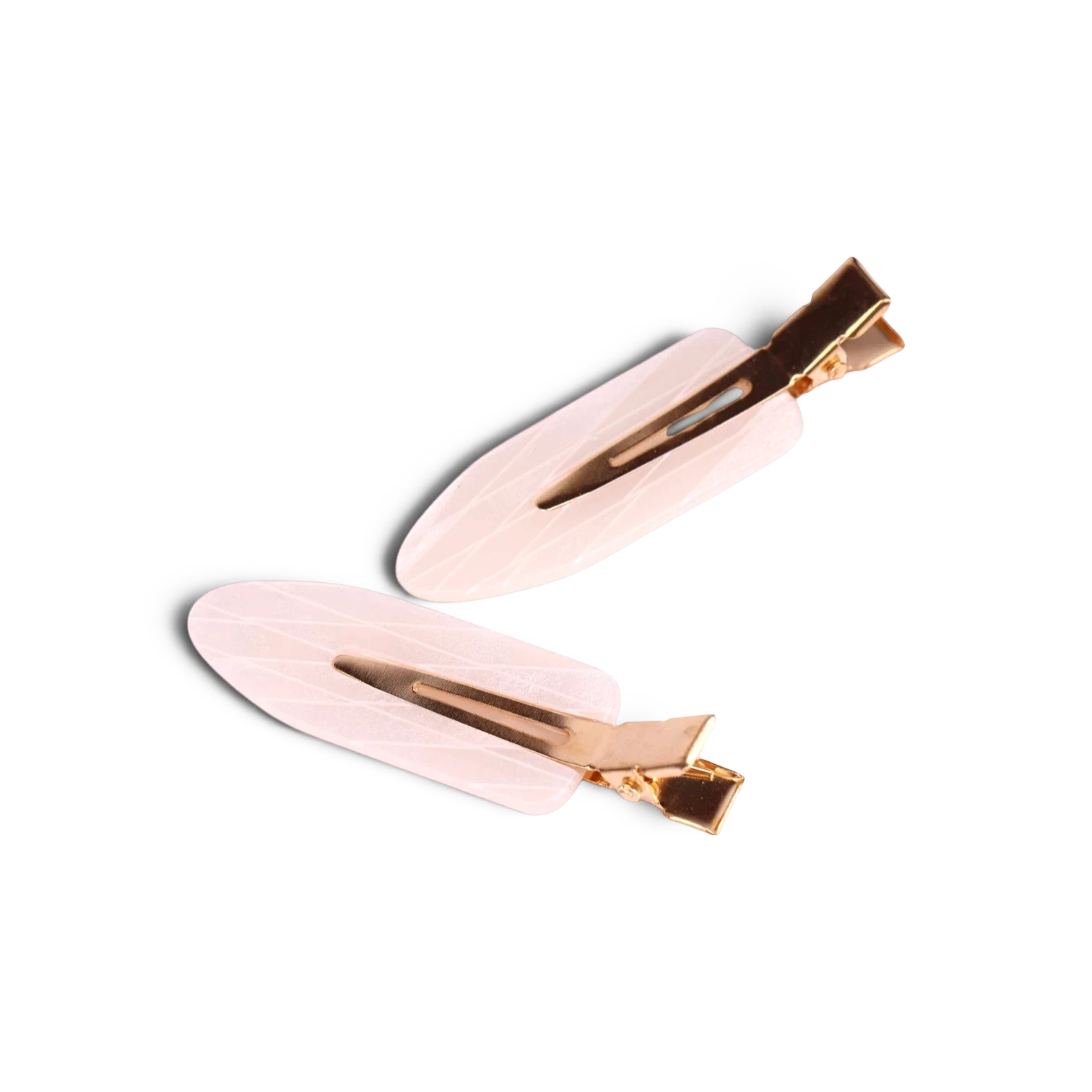 Pair of beige acrylic resin hair clips with gold-tone metal accents and clasps