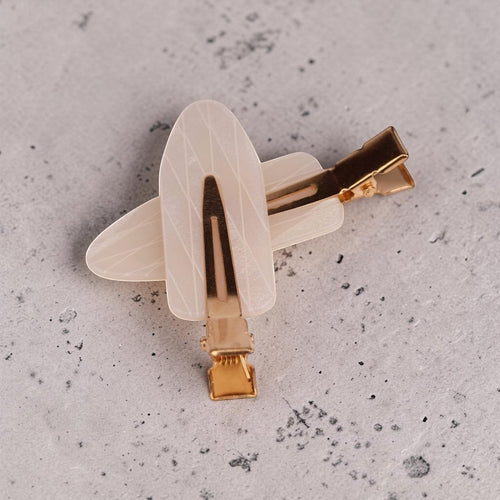 Cream acrylic resin hair clip with gold-tone metal clasp and linear texture detail