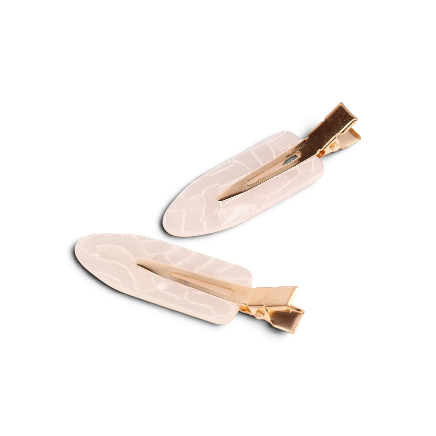 Pair of acrylic resin hair clips with cream textured bodies and gold-tone metal clasps