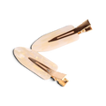 Pair of cream acrylic resin hair clips with gold-tone metal hardware and brown tortoiseshell accents