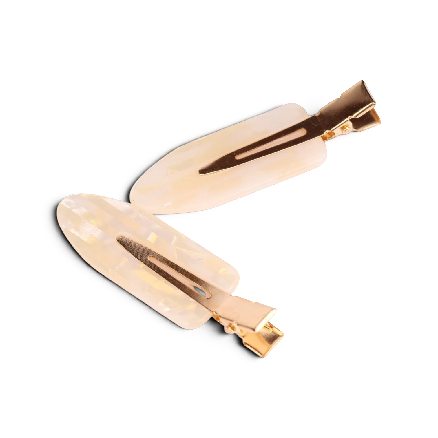Pair of cream acrylic resin hair clips with gold-tone metal hardware and brown tortoiseshell accents