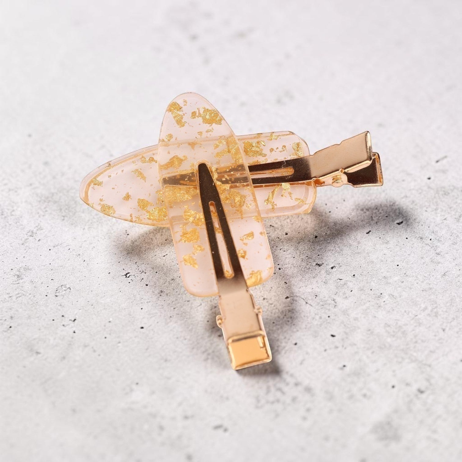 Blush pink acrylic resin hair clip with gold leaf flecks and gold-tone metal hardware