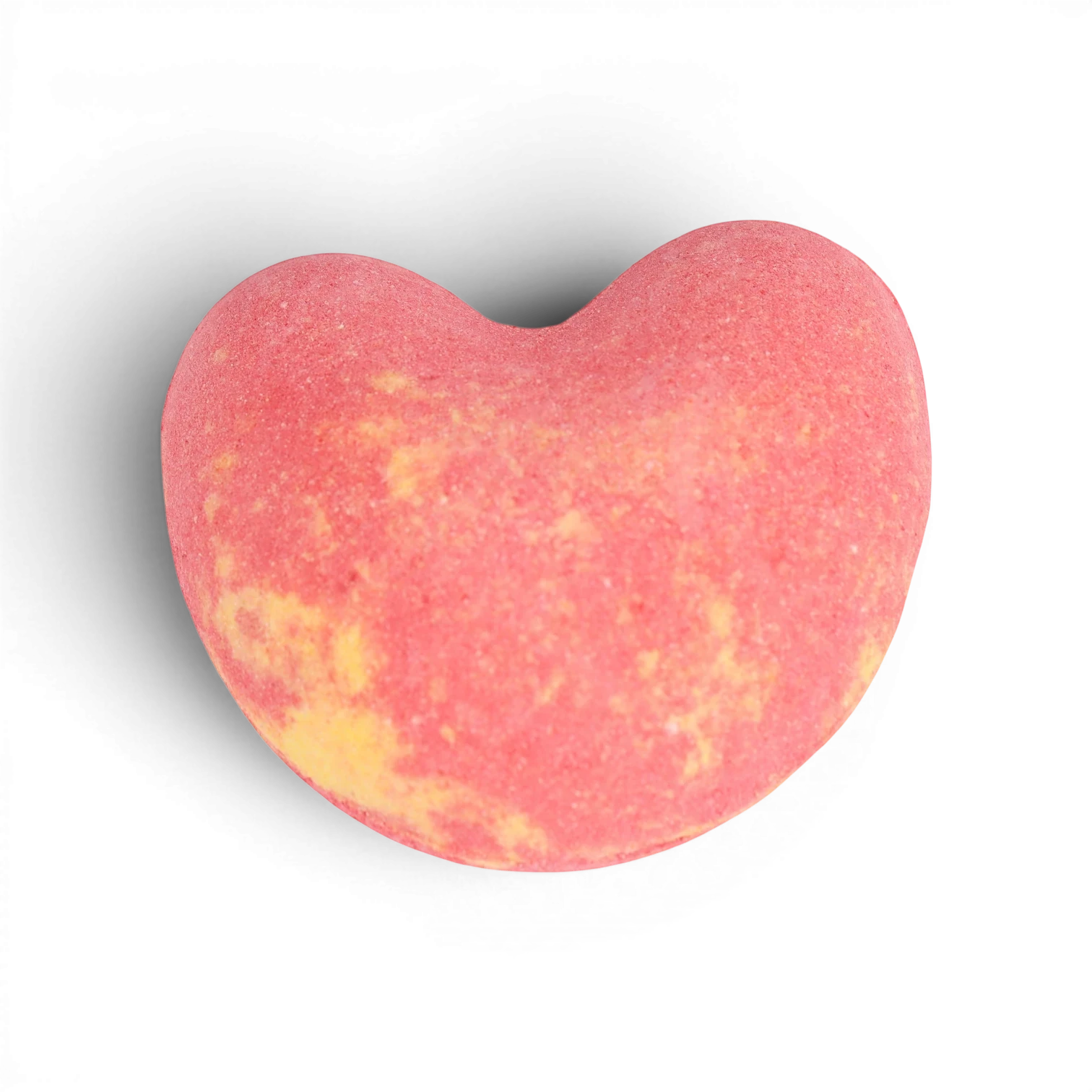 Pink and yellow heart-shaped bath bomb with fizzy texture and natural color swirls