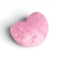 Pink heart-shaped bath bomb with speckled texture and curved design for fizzy bath time