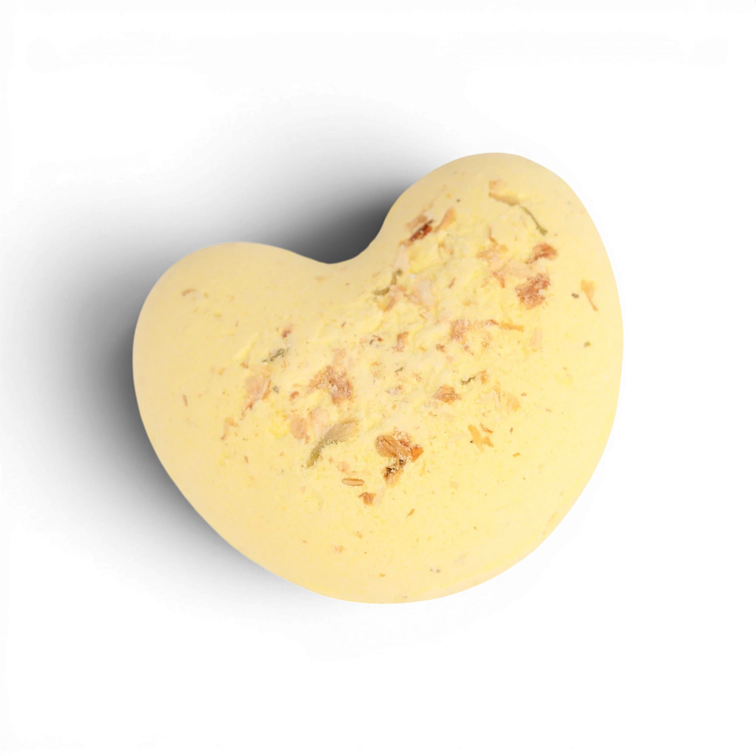 Pale yellow heart-shaped bath bomb with crushed rose petals and botanical flecks