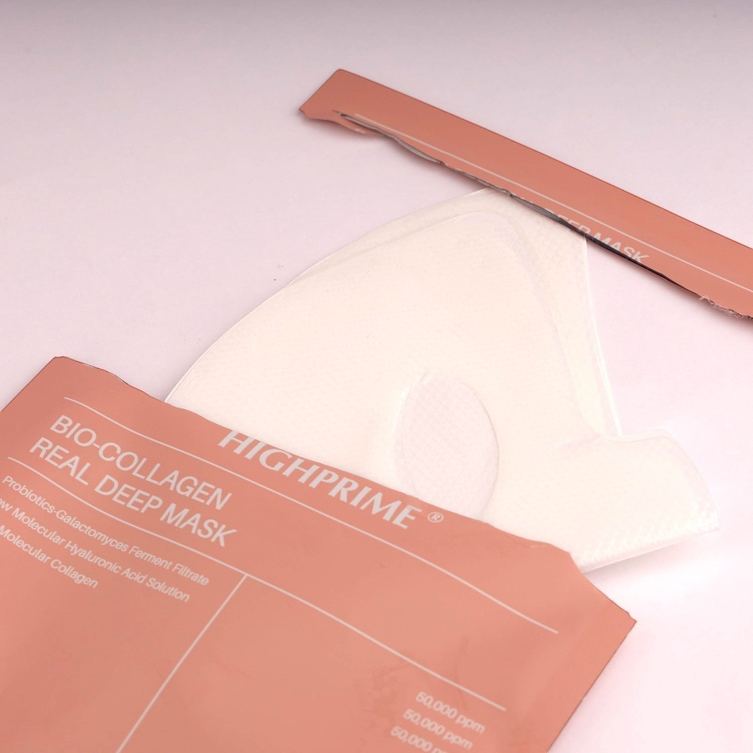 Boxigami Overnight Bio Collagen Face Mask, a white sheet mask with a peach-colored sachet. Deep hydration and moisturizing.