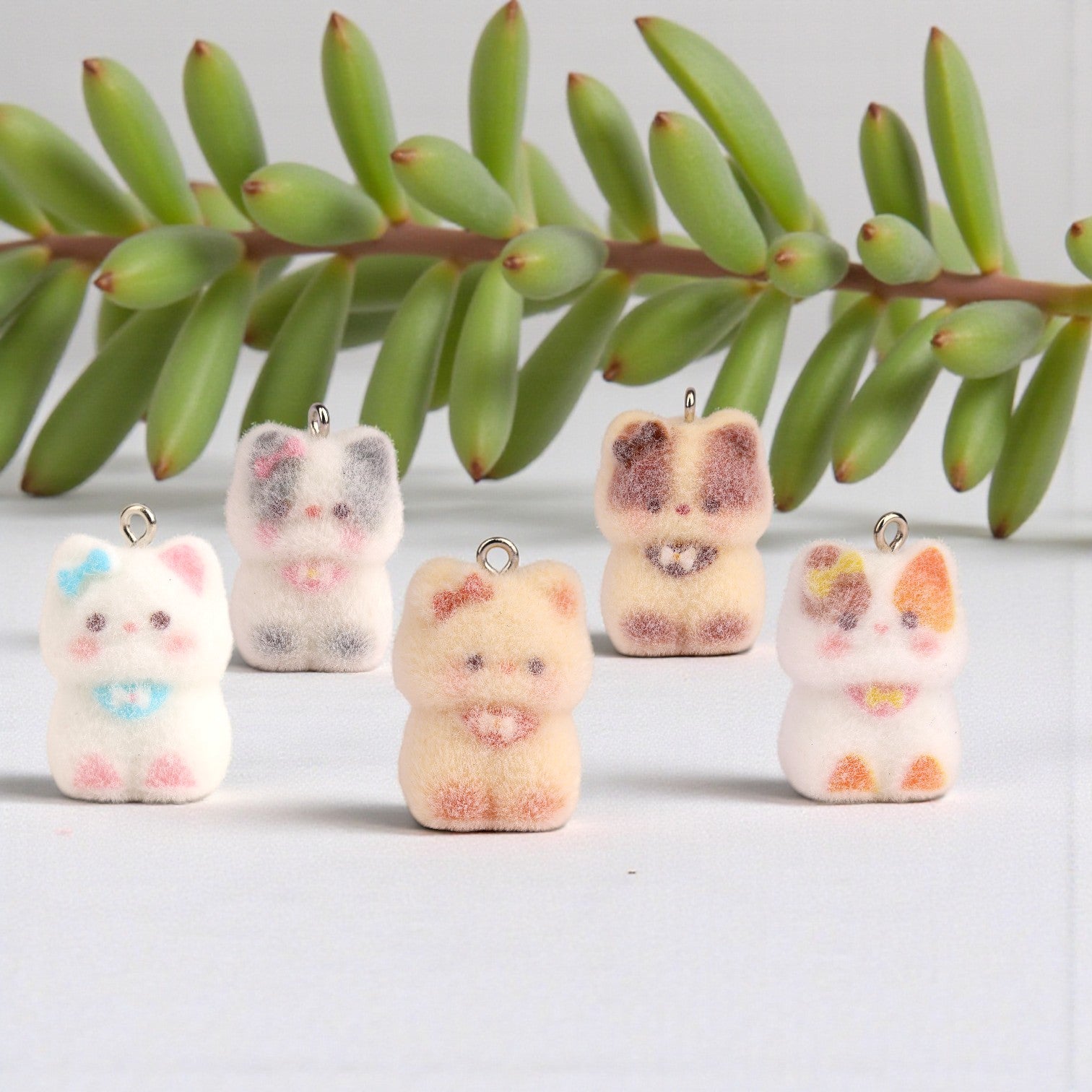 Boxigami mini flocked white cat charm with blue bow and pink accents, perfect for crafts.