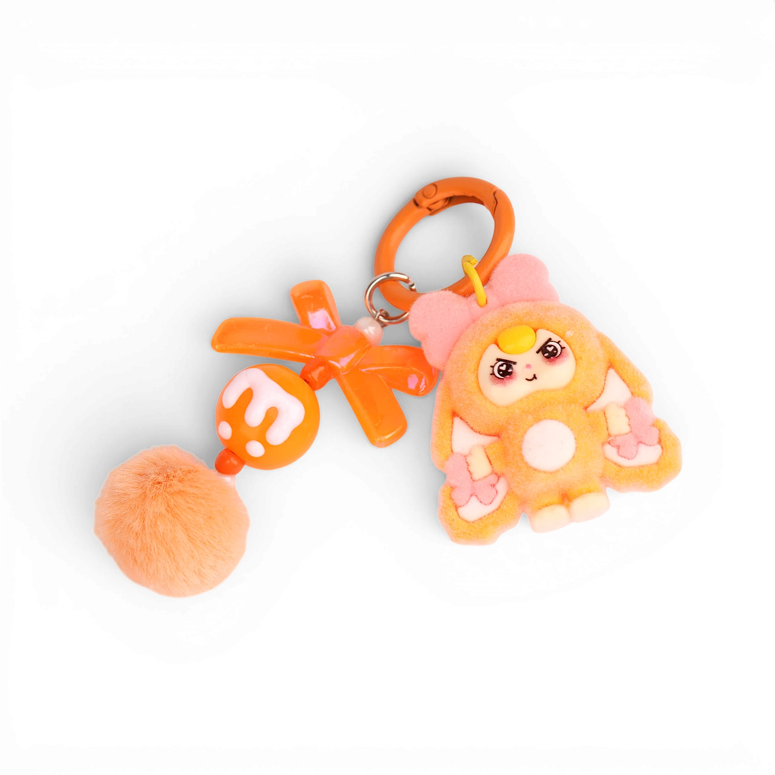 Boxigami llavero de conejo de peluche naranja con detalles de lazo rosa y pompón a juego.